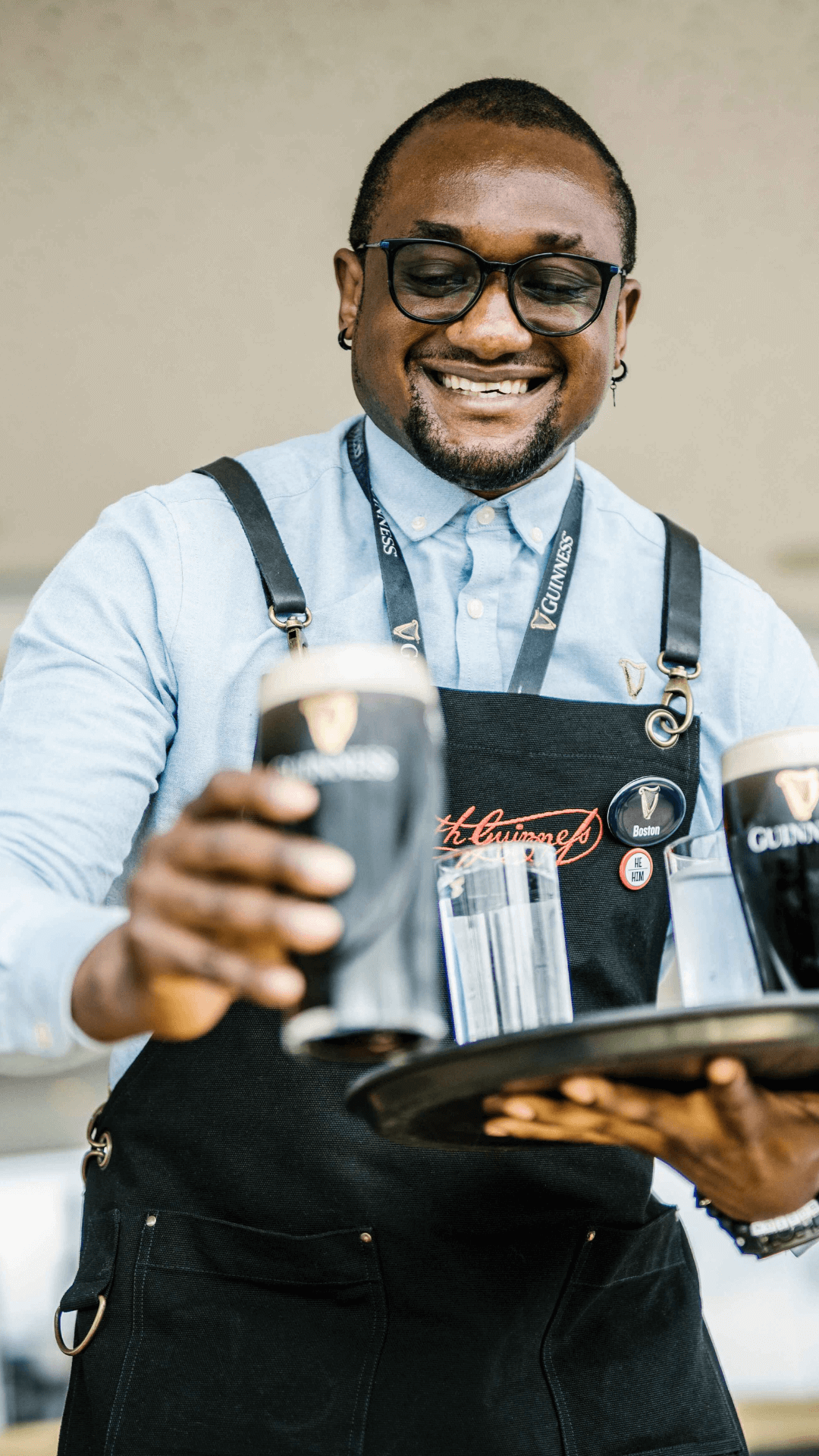 Tour guide at Guinness Storehouse holding a microphone and talking to an audience